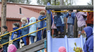 Students at the Little Acorn Day School cover their ears as they wait for the fire alarm to be turned of on Jan. 6. The alarm was tripped when a motor in the school’s heating system got too hot