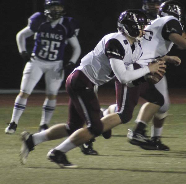 Quarterback Brian Higgins runs with the ball during the Islanders 52-7 win over Lake Washington last Friday. The Islanders will host their first playoff game against Ferndale this Friday at 7:30 p.m.