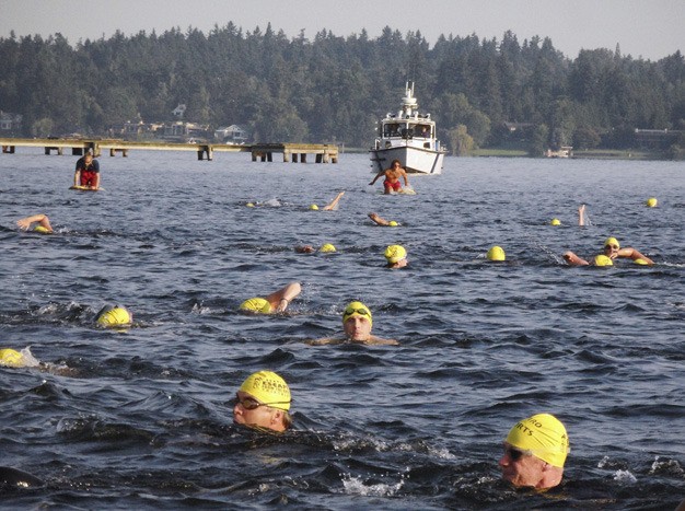 Contestants in the Enviro-Sports ‘Escape from the Rock Triathlon’ swim a half mile to start the race from Luther Burbank Park on Sunday. At the same time