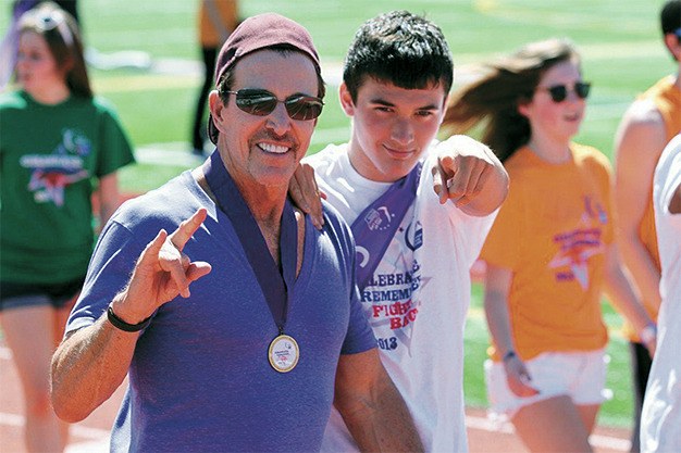 Cancer survivor David Taylor walks with his son