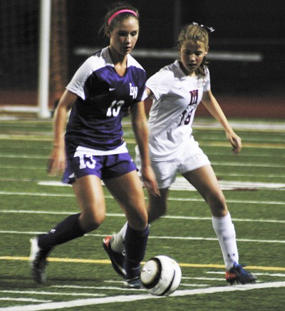 Lake Washington's Emily Robinson controls the ball while Mercer Island's Jamie Mounger tries to take it away. The Islanders lost their first conference game of the season to the Kangs 1-0.