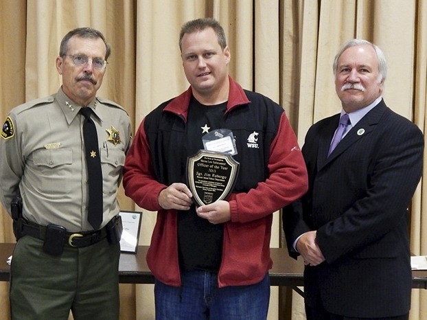 Sergeant Robarge (center) with his award.