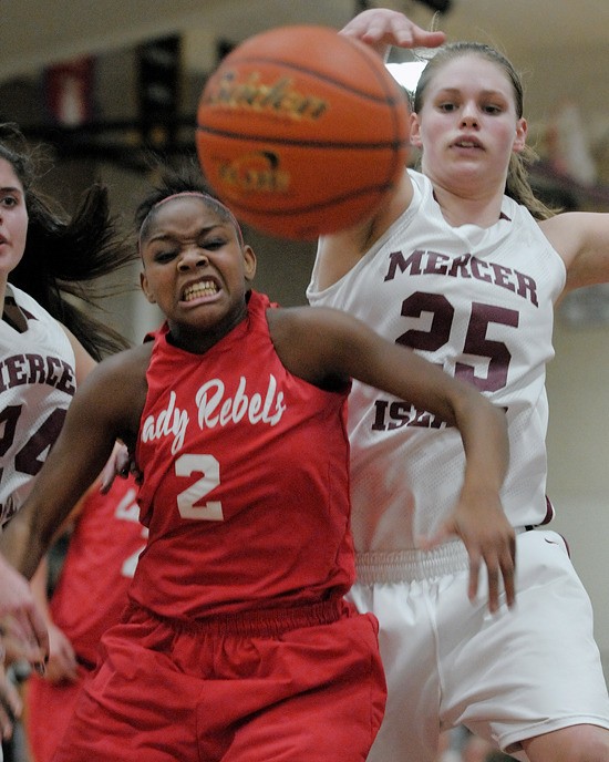 Islander's Christina Williamson (25) blocks a shot by Rebel's Mikayla Jones (2) during a game at Mercer Island on Friday. Juanita won 76-61.