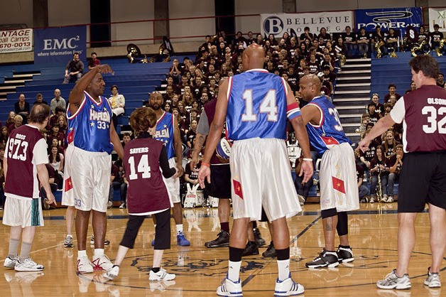 Mercer Island High School English teacher Jan Sayers (14) tries to stay open for a pass during a game against retired members of the Harlem Globetrotters.