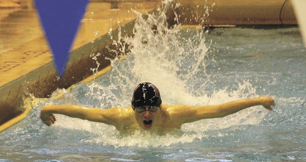 Mercer Island's Harrison Leeds swim the 100 butterfly race during the KingCo championships at UW on Saturday