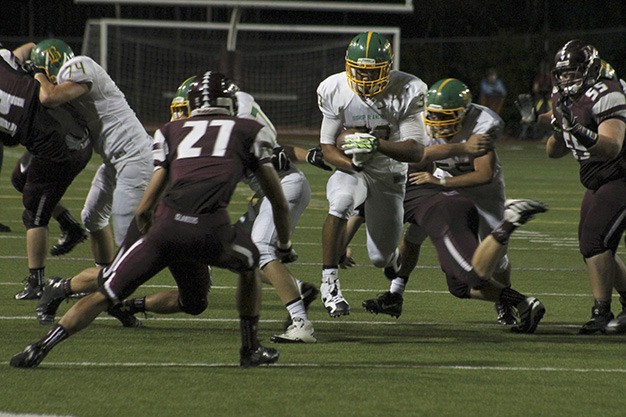 Mercer Island's Cole Northrup (27) zeroes in on Bishop Blanchett running back Oshea Trujillo