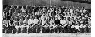 Seventy-seven members of he first graduating class poses next to Mercer Island High School. The class of 1958 recently celebrated its golden anniversary.