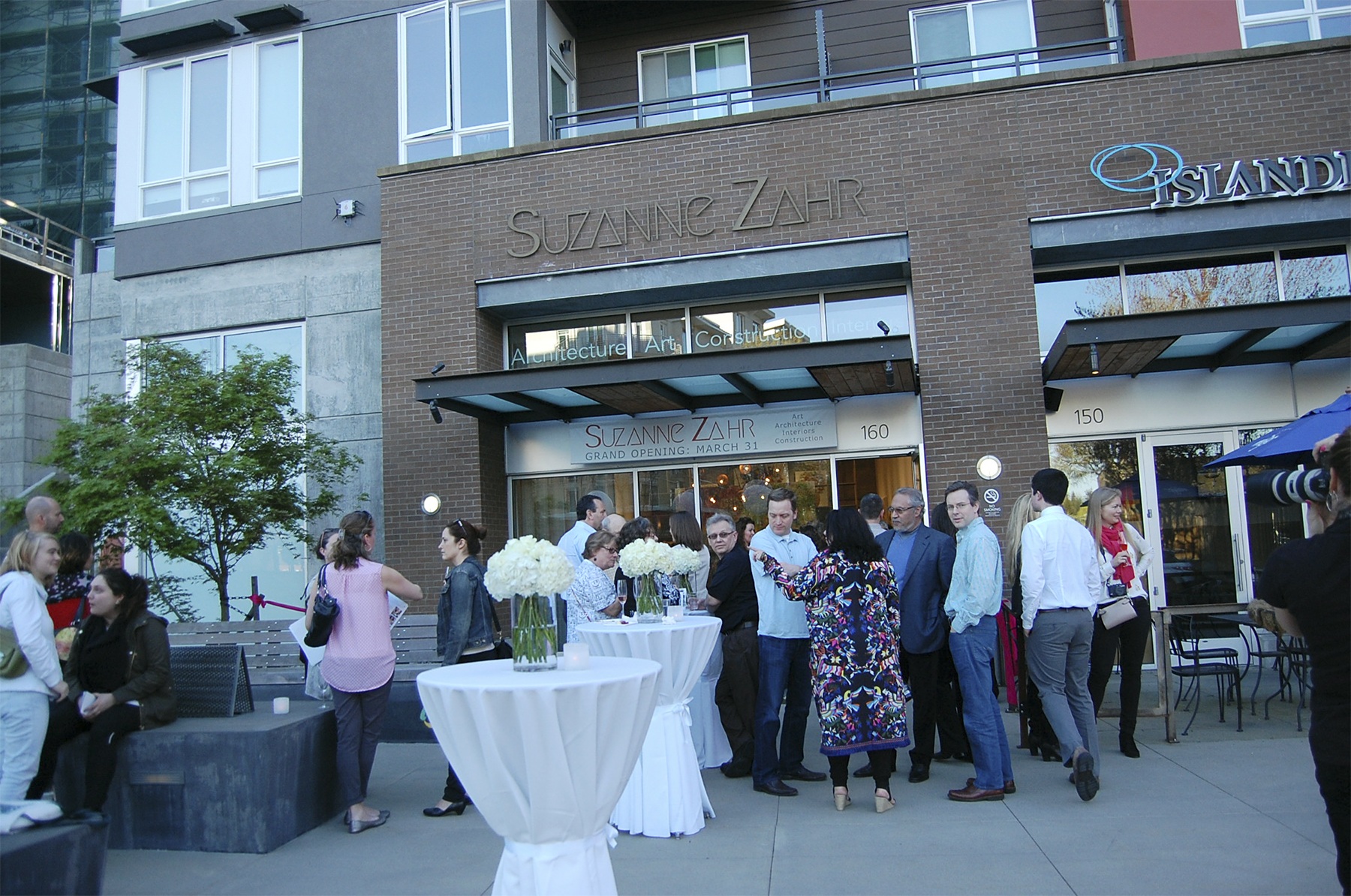 Art appreciators gather at the opening of Suzanne Zahr's design/build studio in Mercer Island on March 31. Zahr is organizing monthly art/wine walks. The next one is July 7