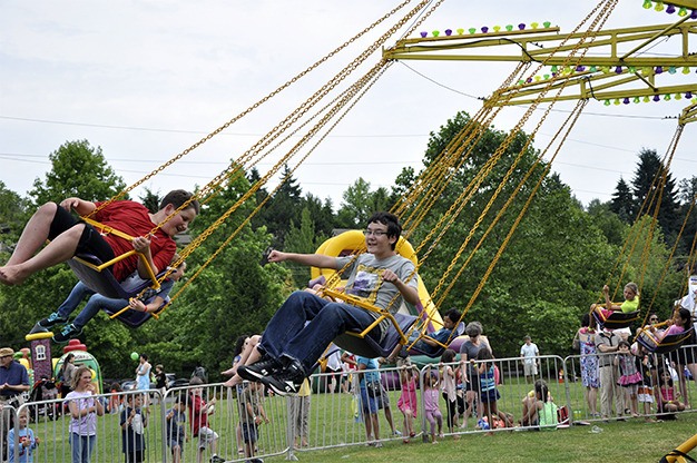 Kids take flight on one of the carnival rides during the 2012 Summer Celebration! festival on Mercer Island. This year’s theme is “It’s Magic