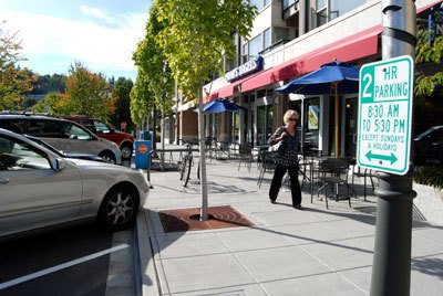 A woman walks past Noah's Bagels