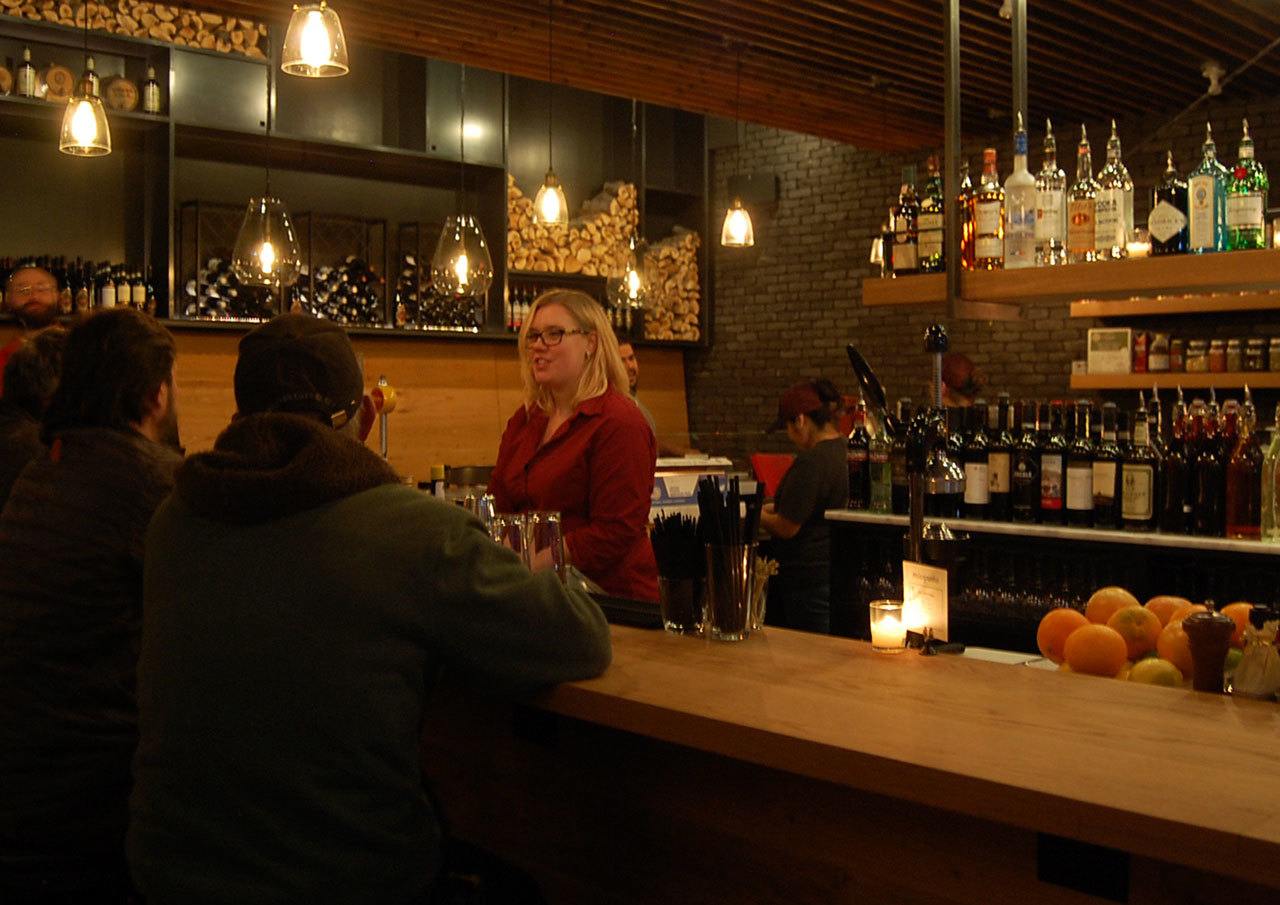 A bartender serves some of the first customers at Mioposto in Mercer Island on Jan. 12. Katie Metzger/staff photo