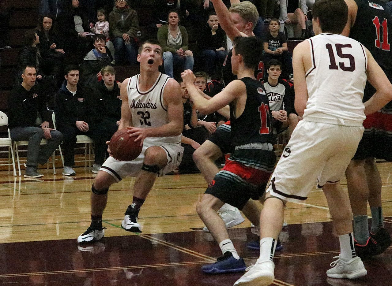 Mercer Island’s Griffin Emanuels fights his way into the paint against Ballard on Feb. 11 at Mercer Island High School. Emanuels was recently named KingCo 2A/3A Defensive MVP (Joe Livarchik/staff photo).