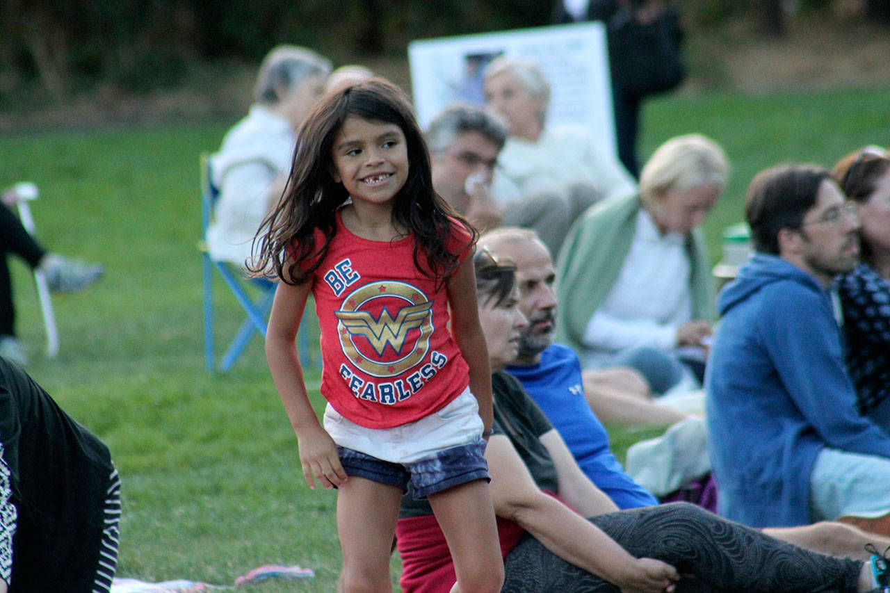 Wearing a “Be Fearless” T-shirt, 7-year-old Florentina Jewell, of Mountlake Terrace, plays during the final Mostly Music in the Park concert on Thursday at Mercerdale Park.