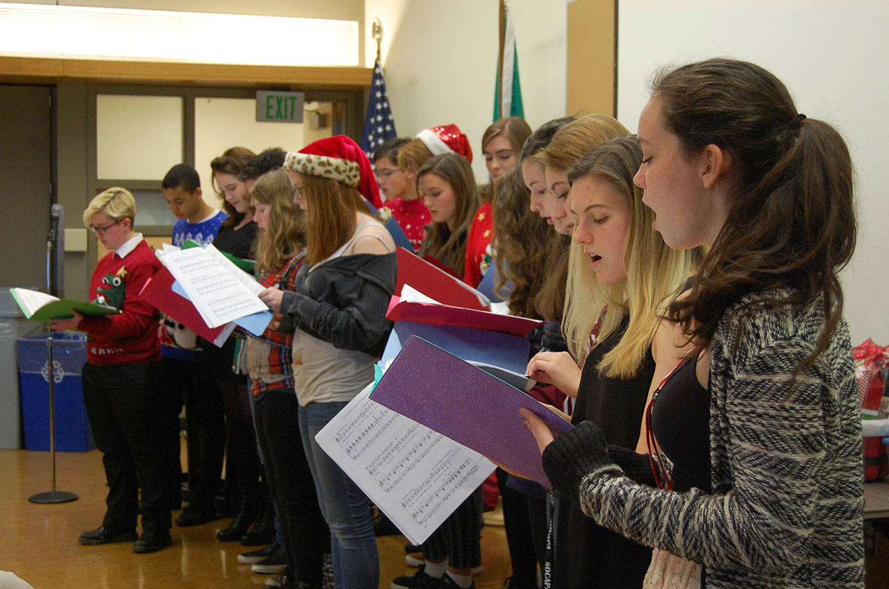 Students from Daniela Melgar’s drama class at Mercer Island High School perform holiday carols at the Chamber of Commerce’s December luncheon. Katie Metzger/staff photo