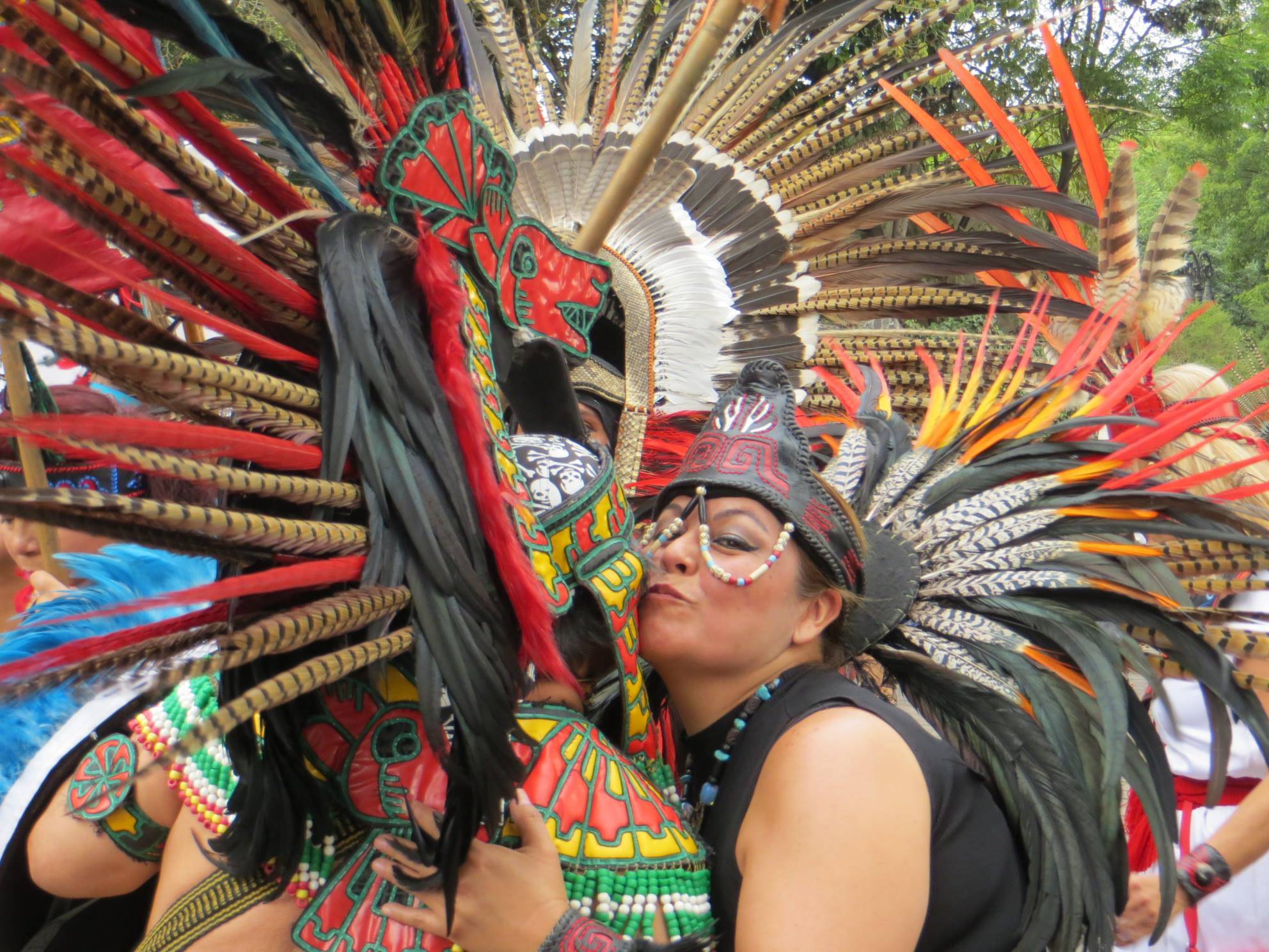 Samantha Pak/staff photo                                 Two indigenous performers embrace during a break in their dancing in Plaza Coyoacán in Mexico City.