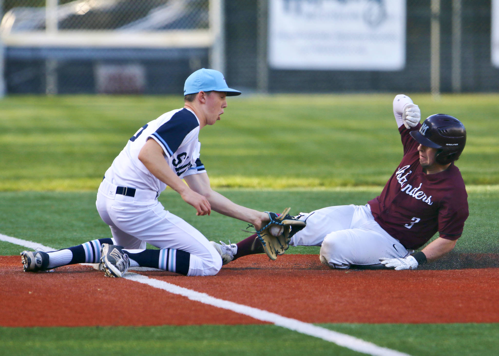 Mercer Island Islanders senior Max Tanzer, right, slides safely into third base on a close play while being tagged by Interlake third baseman Charlie Galanti in the top of the fourth inning. Mercer Island defeated Interlake, 11-0, on April 17 in Bellevue. Photo courtesy of Jim Nicholson