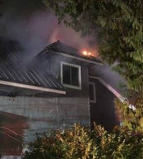 A fire rages at a house in the 3800 block of West Mercer Way. Photo courtesy of the Mercer Island Fire Department