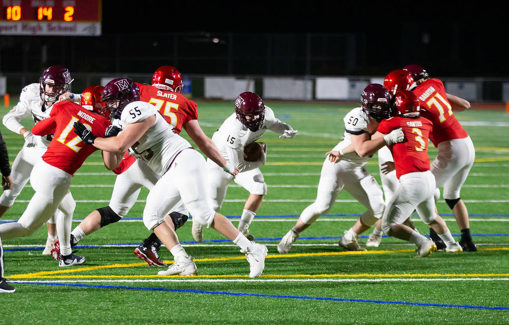 Mercer Island’s Jack Rowe runs through the Newport line. Photo courtesy of David Wisenteiner