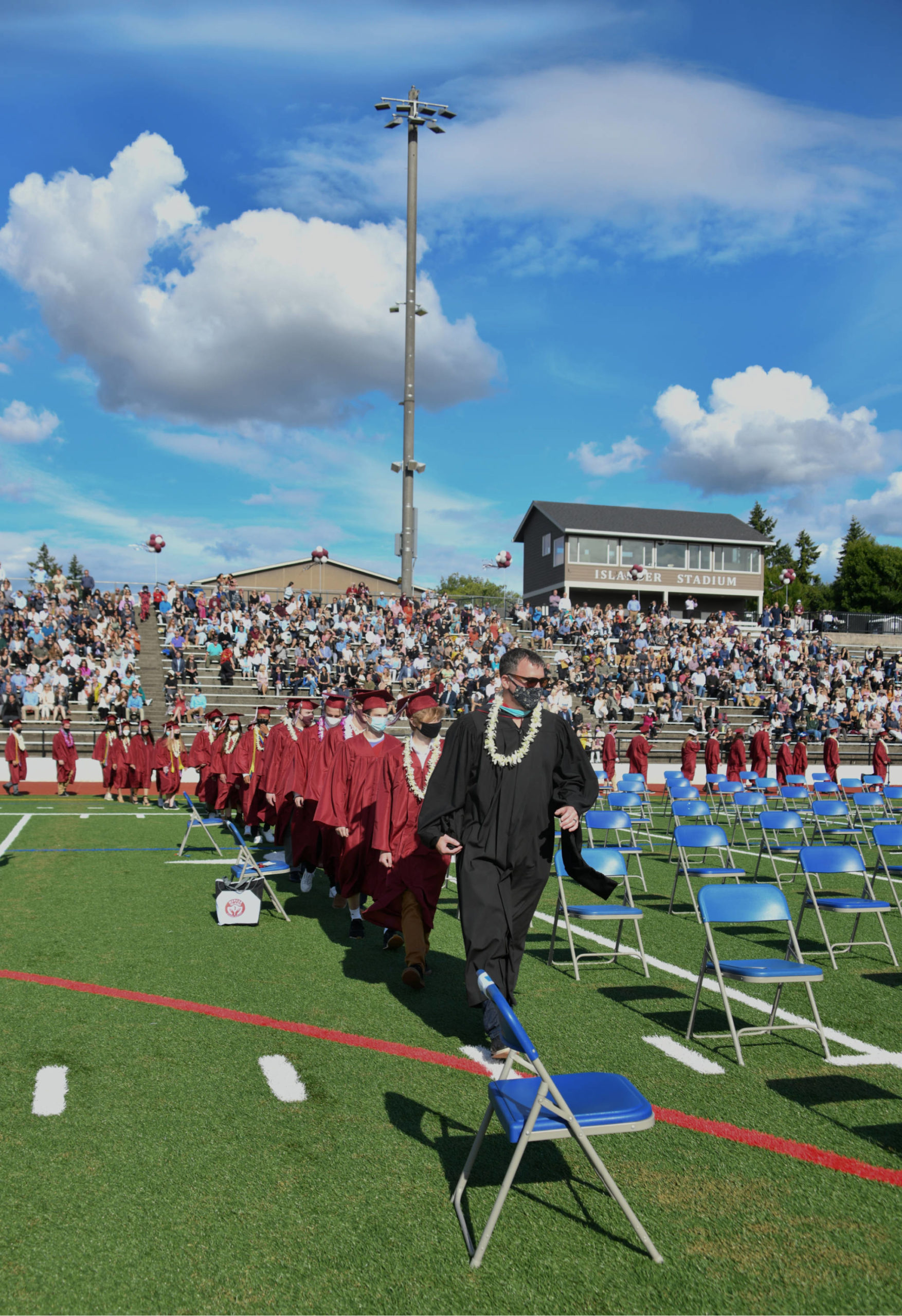 Mercer Island High School class of 2021 graduates head to their seats at the start of the June 10 ceremony. Andy Nystrom/ staff photo