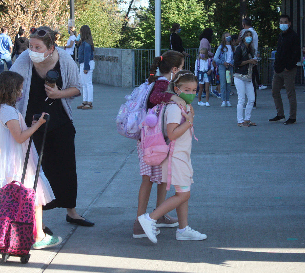 Northwood Elementary School students arrive for their first day of classes on Sept. 1. All Mercer Island School District schools with students in grades 1-12 began in-person, full-time classes on that day. Kindergartners were set to start in-person, full-time classes on Sept. 3. All students and employees will be required to wear masks in their buildings and on school buses. Andy Nystrom/ staff photo