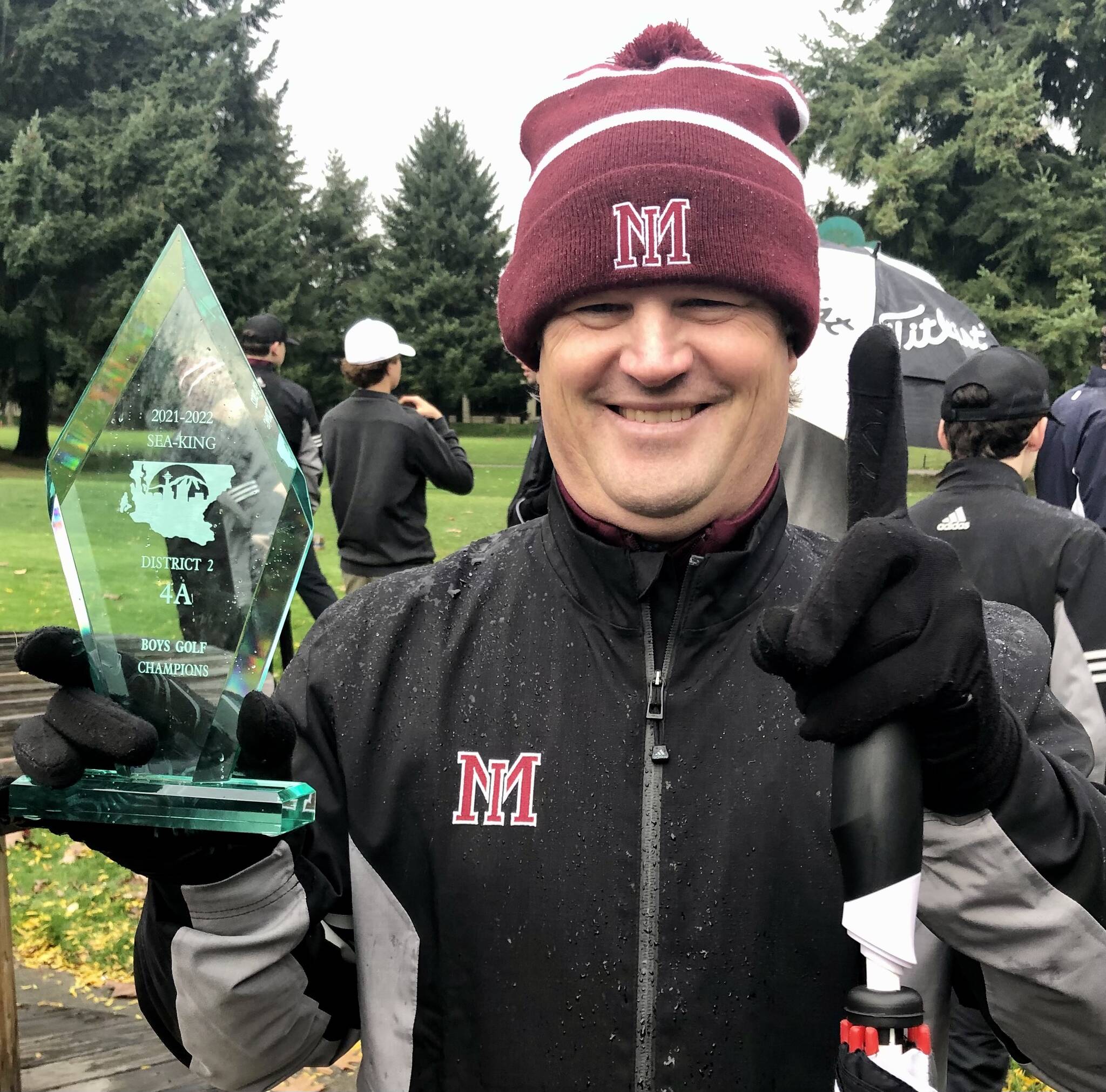 Mercer Island High School boys golf head coach Tyson Peters celebrates the team tying for first at districts and qualifying for state. Photo courtesy of Kym Otte