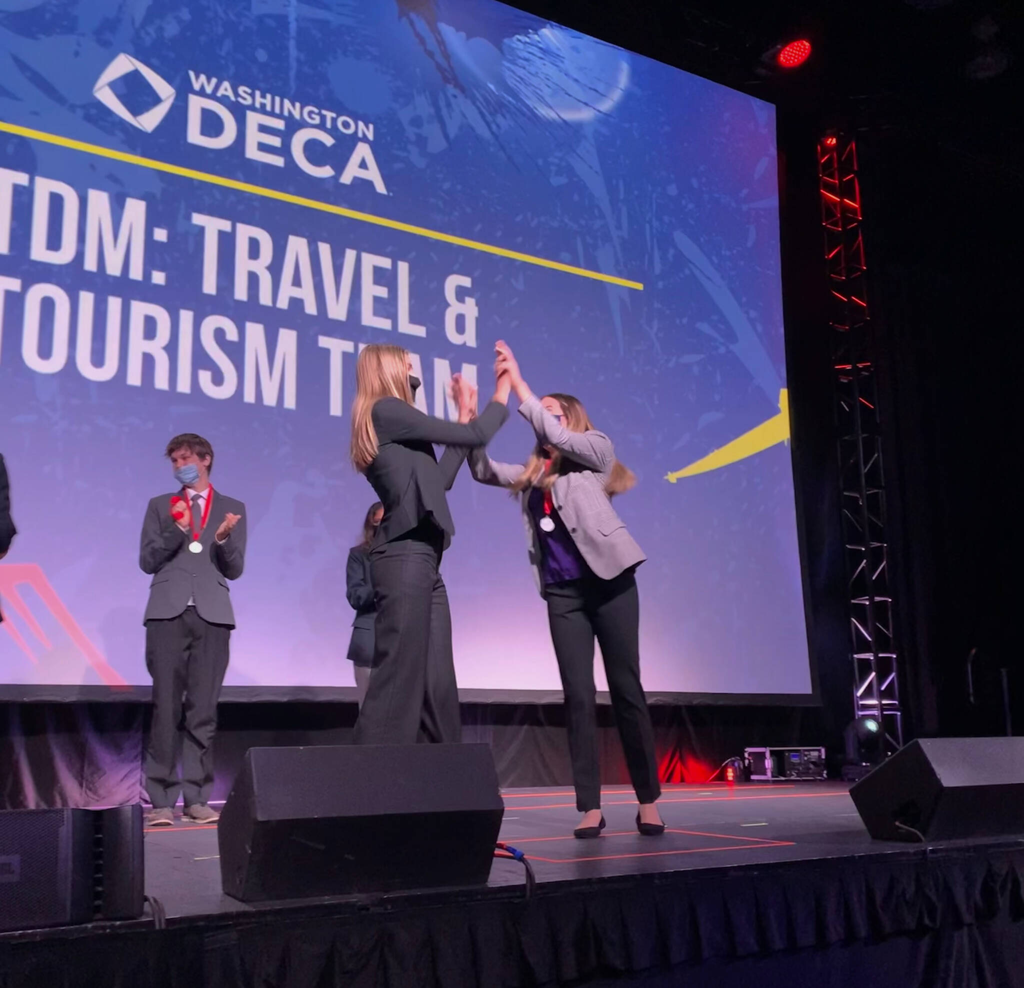 Mercer Island High School seniors Hannah Hobson, left, and Kayla Friedman react after receiving first place in their event, Travel and Tourism Team Decision Making, at the Washington DECA State Career Development Conference, which took place March 3-5 at the Meydenbauer Center & Theatre in Bellevue. Courtesy photo