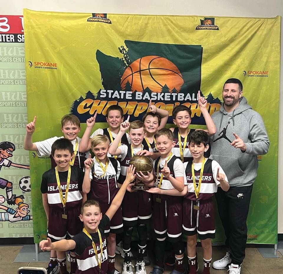 The fourth-grade Mercer Island Select Boys Basketball squad notched the state title in the silver division at the Washington Middle School Basketball Championship on March 20 in Spokane. The team is: kneeling, Drew Munson; front row, left to right, Cal Robinson, Luke Thomas, Paxton Conklin, Cash Coochise and Zachary Ashberg; and back row, left to right, Jacob Sharpe, Colton Gribble, Will Russell, Laign Magee and coach Tony Locascio. Not pictured: Johnny Banchero. Coach Locascio’s squad compiled a 4-0 record, including a 35-21 victory over Enumclaw in the final. The boys also defeated Woodland, 41-23, in the semifinals, Cashmere, 39-23, in the quarterfinals and Inglemoor, 41-15, in the opener. Mercer Island teams in grades 4-8 competed at the tournament from March 18-20 and amassed a 13-7 total record. Courtesy photo