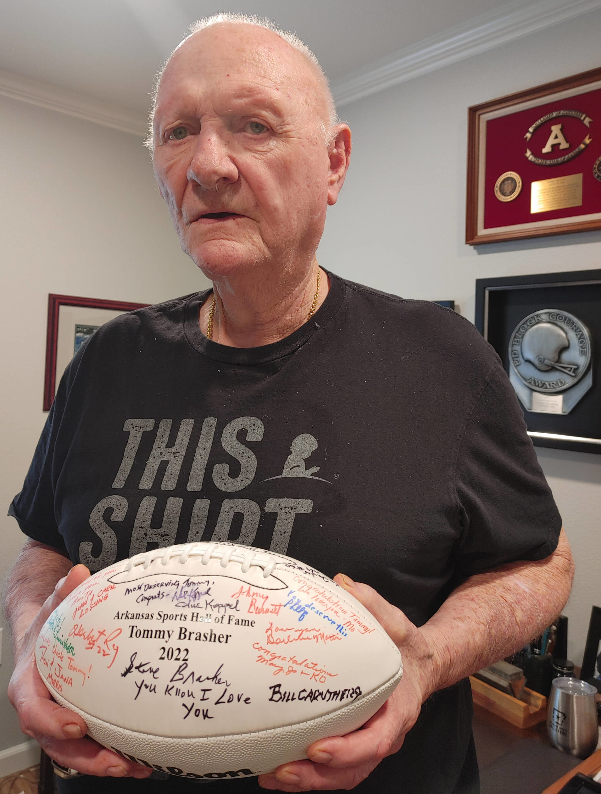 Mercer Island resident Tommy Brasher displays a signed football he received upon his induction into the Arkansas Sports Hall of Fame on April 8. Andy Nystrom/ staff photo