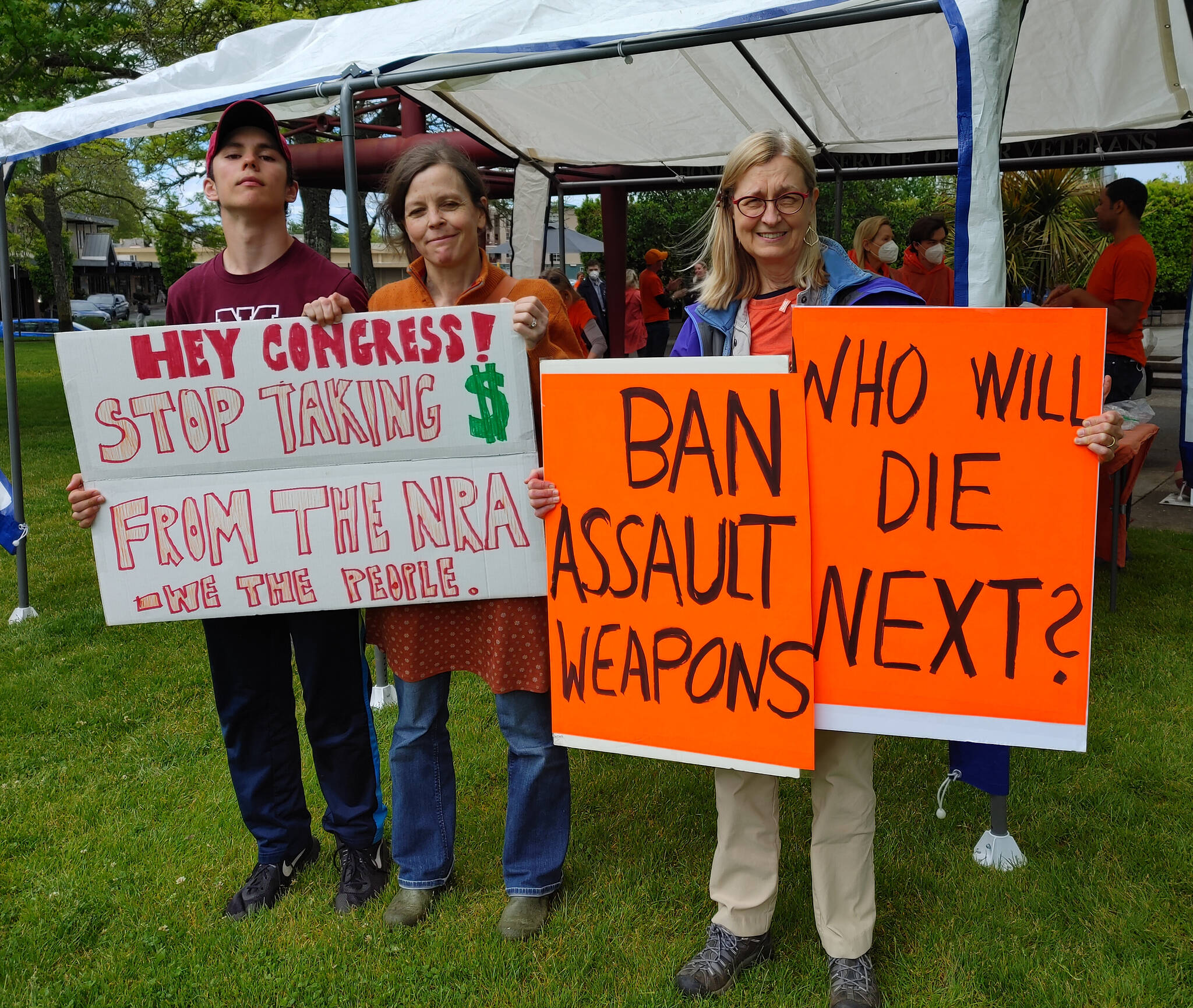 Andy Nystrom/ staff photo 
From left to right, Ben Murawski, Judith Anderson and Caroline Haessly brought end gun violence signs to the Mercer Island PTA Committee on Gun Violence Prevention gathering on June 3 at Mercerdale Park.