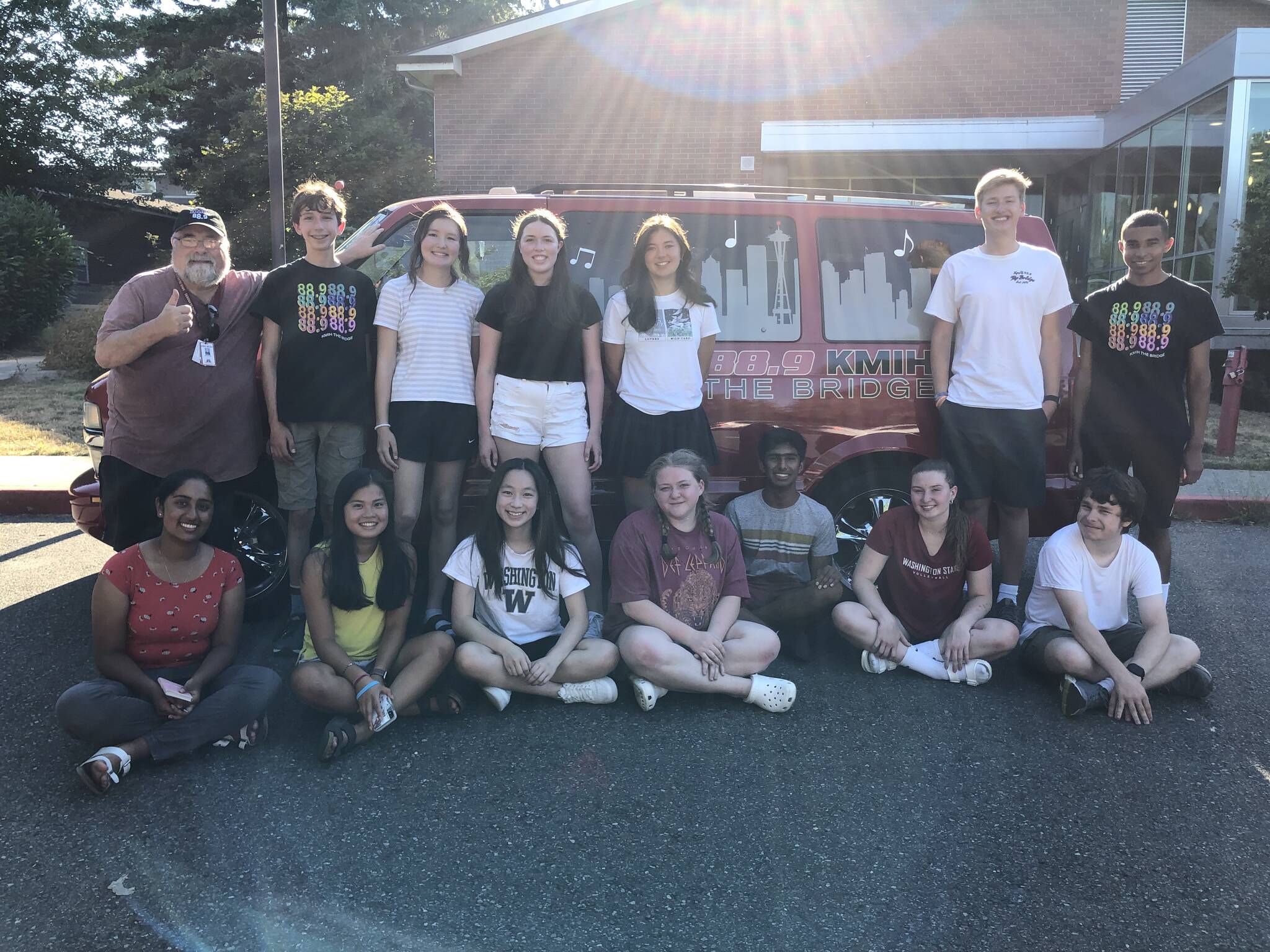 KMIH 88.9 The Bridge staff: Seated left to right — Amuktha Josyula, Hayley Nguyen, Chloe Yang, Ellie Sadlier, Sidh Shroff, Sophie Prock and Theodore Freeman. Standing left to right — Joe Bryant, Anatoly Odievich, Sophia Azzano, Annabelle Hegarty, Lauren Suzuki, Andrew Howison and Miles Avilez. Courtesy photo