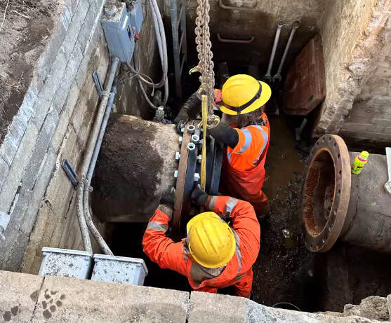 Seattle Public Utilities employees work to repair the water valve on a 24-inch pipe located on the Bellevue side of Interstate 90. It was successfully repaired at about 8:30 a.m. on Thursday. Photo courtesy of the city of Mercer Island