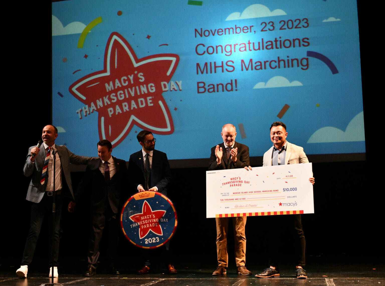 Pictured from left to right on April 1, 2022, at Mercer Island High School, Macy’s Thanksgiving Day Parade creative producer Wesley Whatley, Mercer Island High School marching band directors Kyle Thompson, Jacob Krieger and Parker Bixby and Macy’s Bellevue store manager Ryan Ramoso. Andy Nystrom/ staff photo