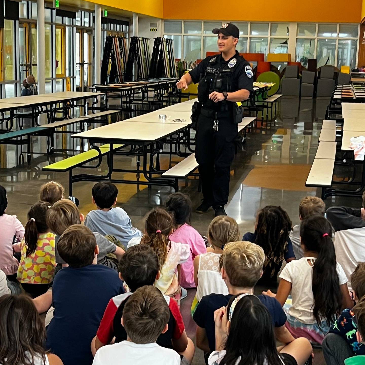 Last month, Mercer Island Police Department school resource officer Foster Barragan visited Northwood Elementary on the last day of summer school and spoke with students about his role, showed them the inner workings of his police vehicle and ran the lights and siren. Photo courtesy of the Mercer Island School District