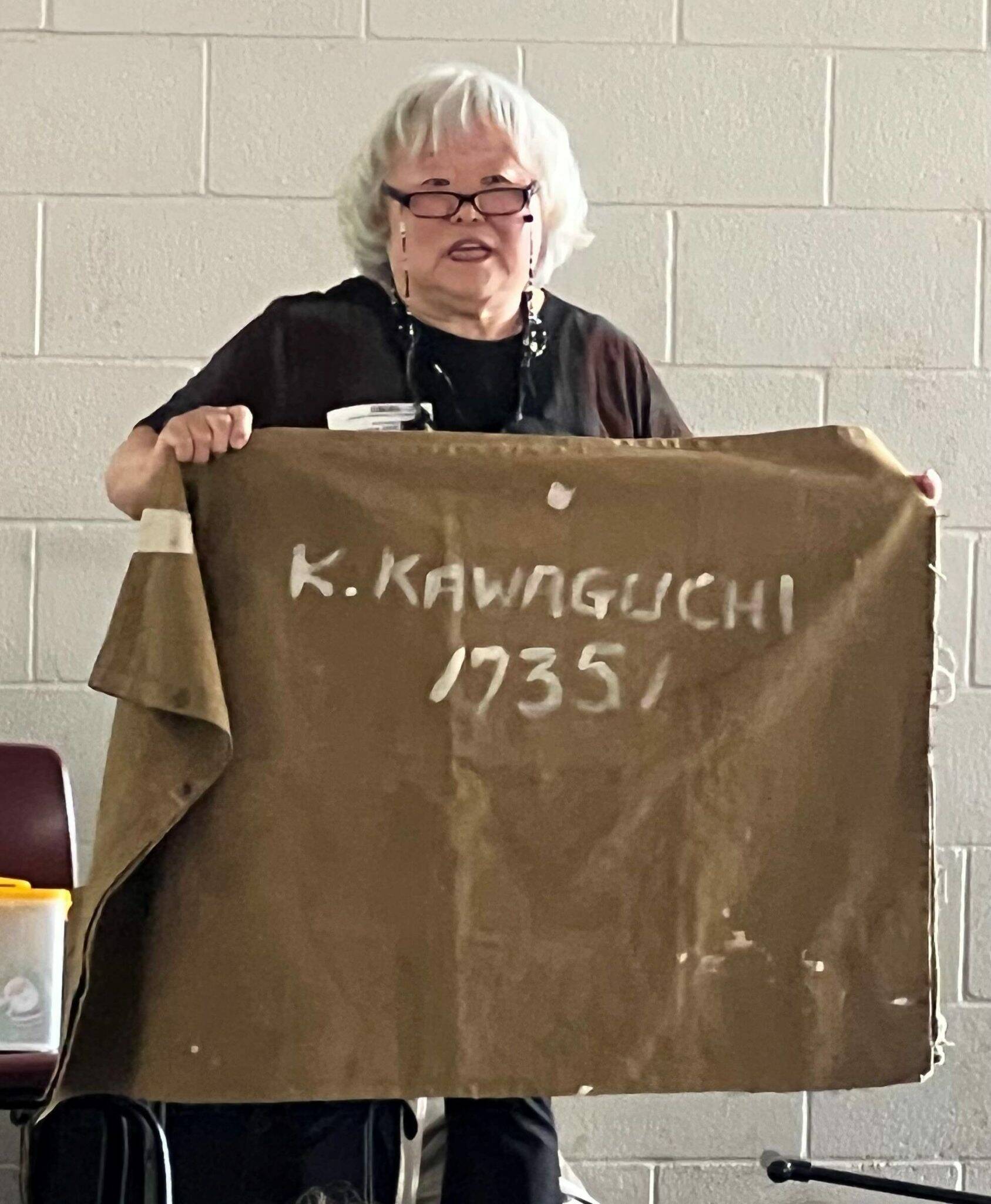 In 2022, Judy Kusakabe shows West Mercer Elementary fourth-graders her family gunny sack, where they had to place their belongings when they were sent to the prison camp. Photo courtesy of Soyun Chow