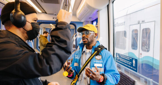 A Sound Transit fare ambassador checks with a light rail rider. COURTESY PHOTO, Sound Transit