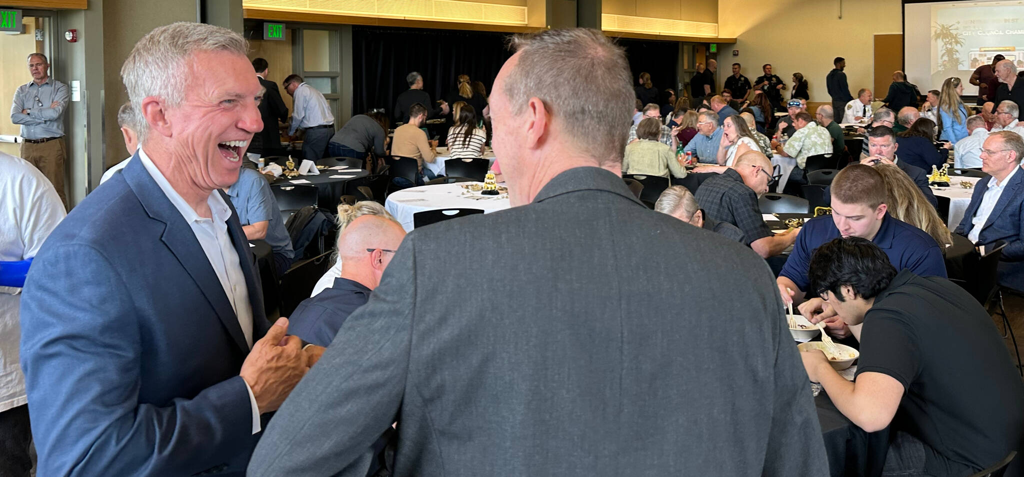 Mercer Island Police Department Chief Ed Holmes interacts with a well-wisher in his signature laugh during the chief’s retirement celebration on June 14 at the Mercer Island Community and Event Center. Holmes served the department for 30 years, including the last 18 as chief. Story and more photos to come. Photo courtesy of Greg Asimakoupoulos