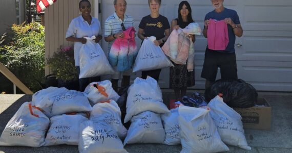 From left to right: Mercer Island Rotarians Novelett Cotter, Benson Wong, Pat Turner, Dana Weiner of Stroum Jewish Community Center, Rotarian John Hamer. The MI Rotary members collected 20-plus bags of children’s lost and found clothing from SJCC and Mercer Island School District. They washed, sorted and folded all the clothes, which will now be donated to local nonprofit organizations that help low-income families. Courtesy photo by Mariana Parks