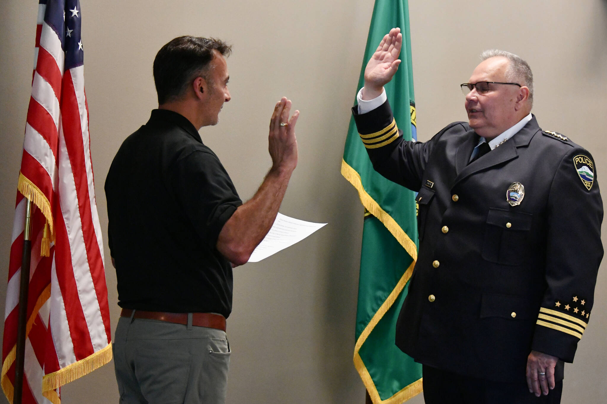 Mercer Island Mayor Salim Nice swears in new Mercer Island Police Department Chief Chris Sutter on the afternoon of July 24 in the city council chambers at the Mercer Island Community and Event Center. Andy Nystrom/ staff photo