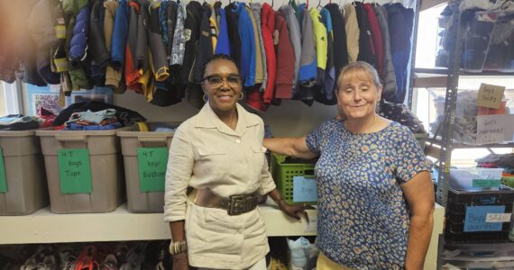 Novelett Cotter of Mercer Island and Katrina Dohn of Tukwila Rotary Clubs, at “Kids Without Borders” Children’s Clothing Bank, started by Dohn. (Photo by John Hamer)