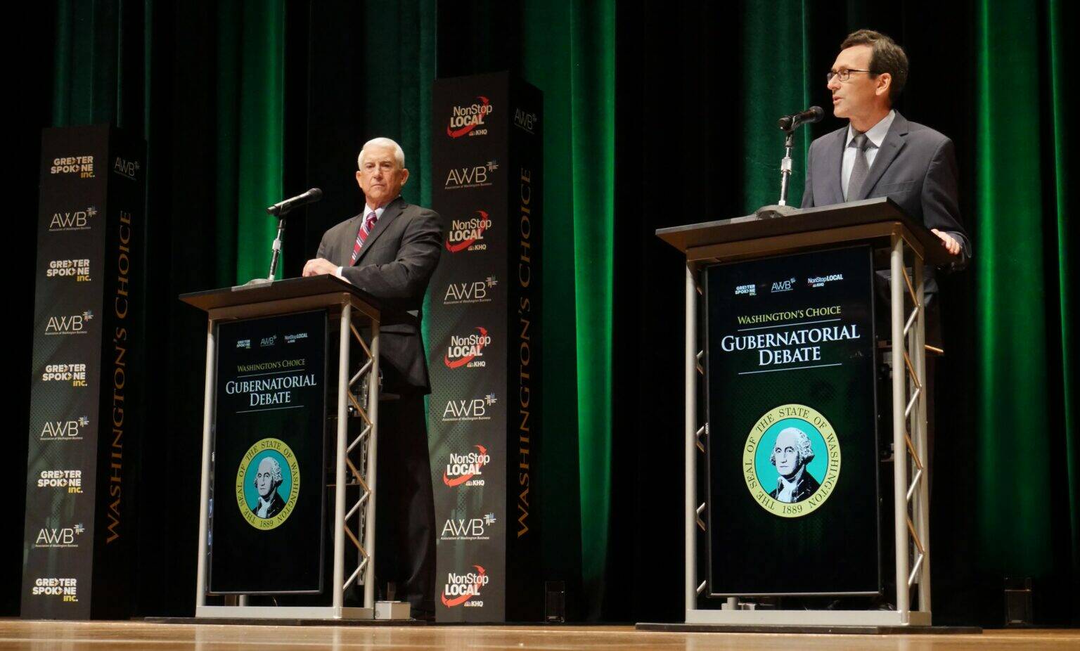 Former Congressman Dave Reichert, a Republican, left, and Washington state Attorney General Bob Ferguson, a Democrat, right, are seen on stage during the second debate of the 2024 Washington state governor’s race, Sept. 18, 2024, in Spokane, Wash. (Bill Lucia/Washington State Standard)