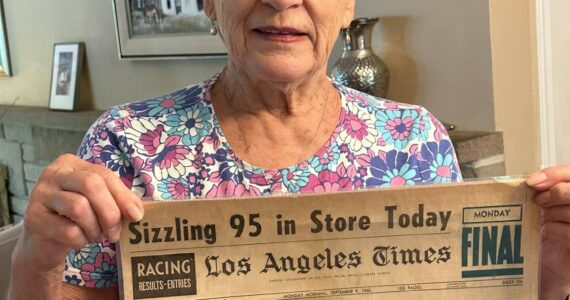 Greg’s neighbor Linda Nicholl holding front page of Sept 9, 1963 LA Times featuring her father’s cover story Photo courtesy of Greg Asimakoupoulos