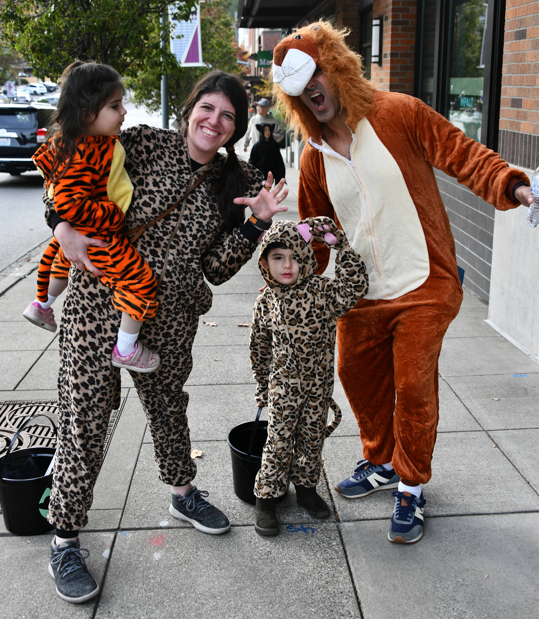 Mercer Island residents came out in droves to participate in trick-or-treating in Town Center on Oct. 25. The free, family-friendly city of Mercer Island event featured participating businesses handing out goodies. Here we have the Taing family of Caitlin, Rahul and youngsters Maya and Leo. Andy Nystrom/ staff photo