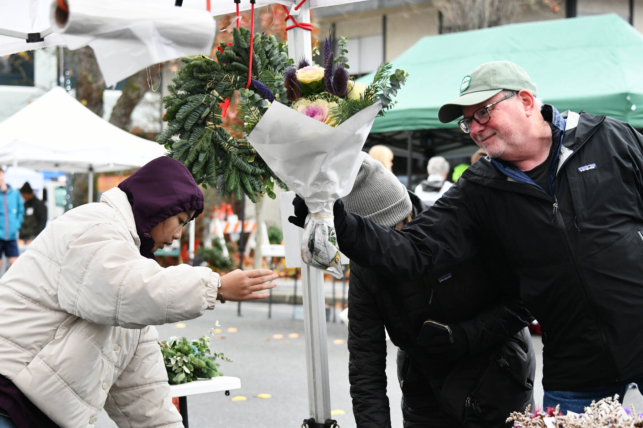 There were plenty of vendors and attendees at the Mercer Island Harvest Market on Nov. 24 near Mercerdale Park. Vendors sold fresh produce, homemade goods and more, and the event also included free hot chocolate, food trucks and live music from guitarist/singer/songwriter and market fan favorite Zach Lombardo. Andy Nystrom/ staff photo