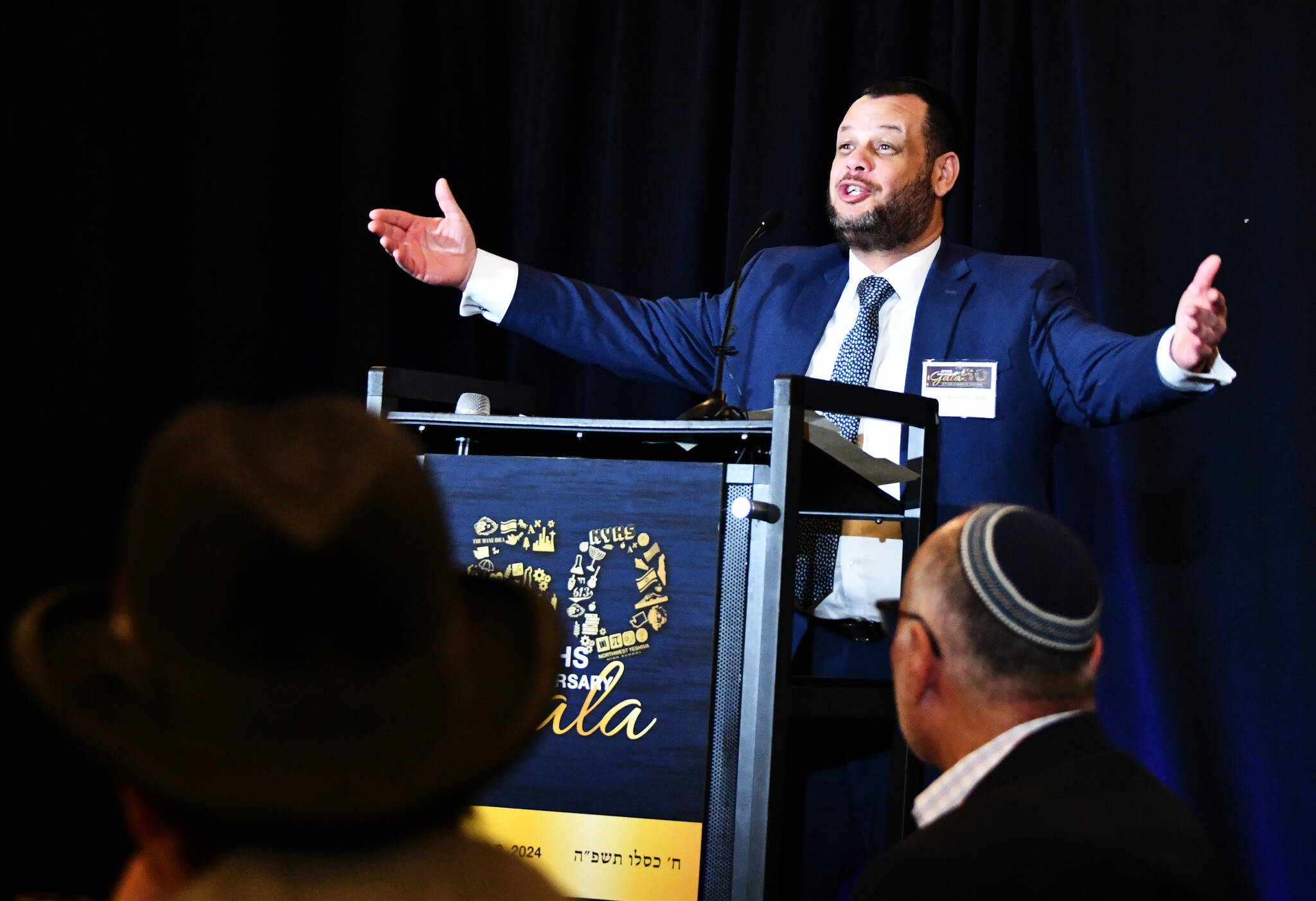 Northwest Yeshiva High School Head of School Rabbi Yehuda Gabay excitedly greets attendees at the school’s 50th Anniversary Gala Dinner on Dec. 8 at the Island Synagogue. Andy Nystrom/ staff photo