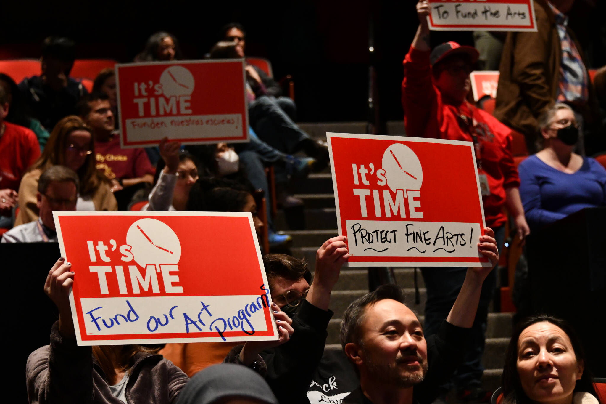 Attendees display their signs at the “School Funding Crisis” Eastside Town Hall on Jan. 8 at Sammamish High School in Bellevue. Andy Nystrom/ staff photo